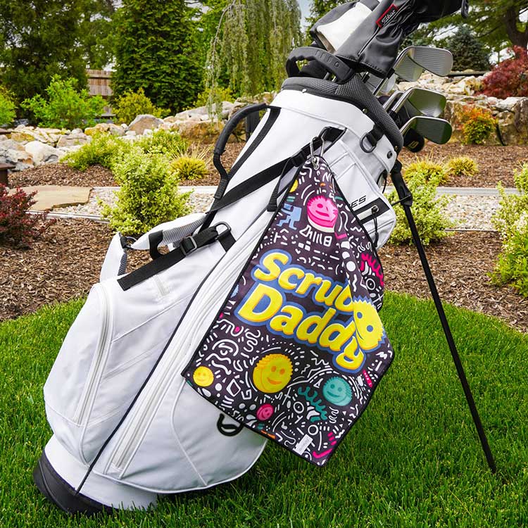 Scrub Daddy Limited Edition Sports Towel hanging off of a golf bag